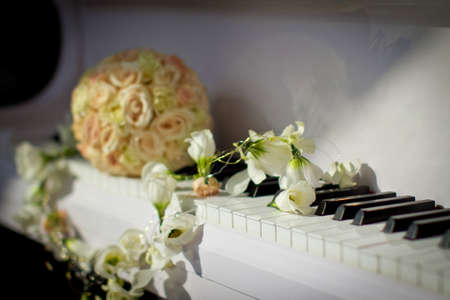 bride's bouquet on the piano, wedding decorationの写真素材