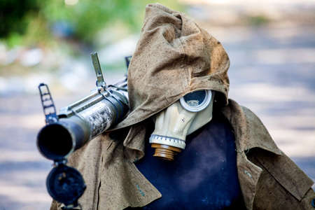 War actions aftermath, Ukraine and Donbass conflict, dummy for deception of snipers of the opponent in military clothes and with the grenade launcher on a shoulderの写真素材
