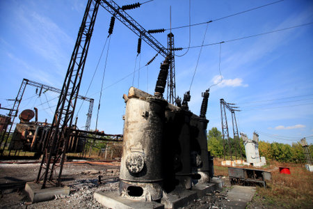 Electric power substation damaged by shelling, burnt coils, dangling wires, war actions aftermath,...
