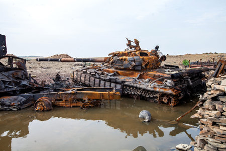 War actions aftermath, Ukraine and Donbass conflict, destroyed tank of the Ukrainian armed forcesの写真素材