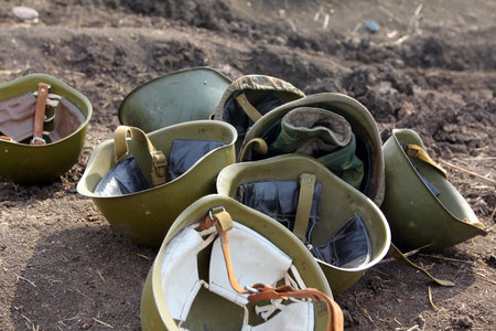 soldier's helmets lie on the ground.