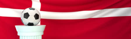 A football (soccer) ball stands on pedestal in front of Denmark flag, 3D render illustration with depth of fieldの写真素材