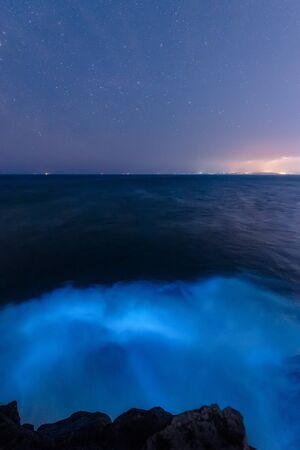 Seaside, beautiful starry sky and blue wavesの写真素材