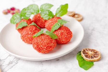 Lychee shaped steamed buns on a white plateの写真素材