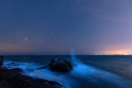 Seaside, beautiful starry sky and blue wavesの写真素材