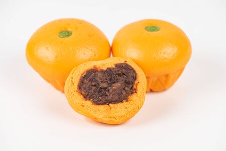 Cute pork buns in a form of oranges on white backgroundの写真素材