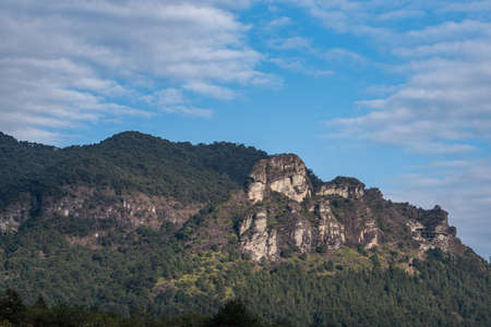 Blue sky and white clouds, all kinds of stones and plants on the mountainの写真素材