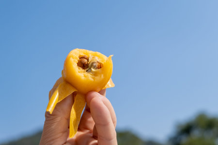 He held the eaten loquat fruit in his handの写真素材