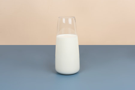 White milk and dairy products are placed on a yellow and gray backgroundの写真素材