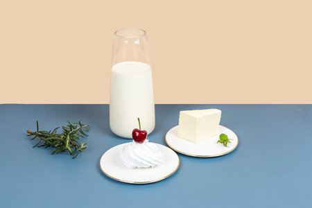 White milk and dairy products are placed on a yellow and gray backgroundの写真素材