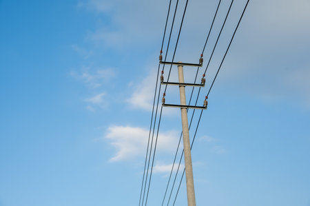 Street lights and wires under the blue skyの写真素材