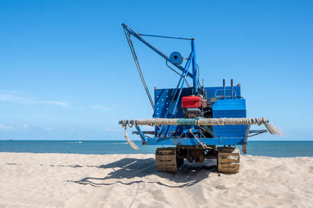 Old fishing machines parked on the beachの写真素材
