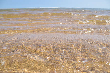 The crystal clear sea water is on the beach in summerの写真素材