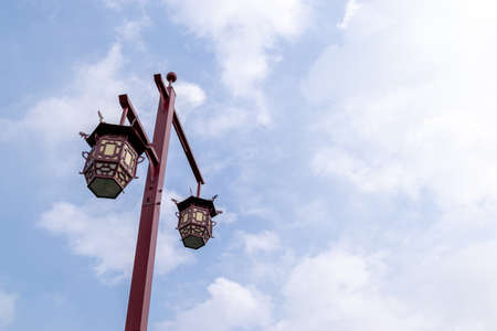 Red street lights under blue sky and white cloudsの写真素材