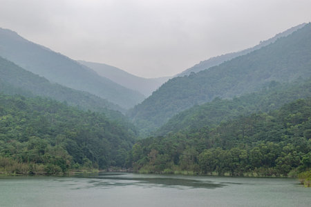 The reservoir after the rain reflects the mountains and forestsの写真素材
