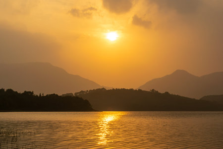 The sun dyed the sky and water goldenの写真素材