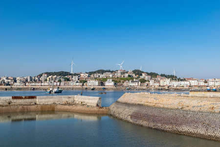 The wharf of the fishing village and the dam made of stonesの写真素材