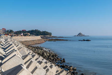 The wharf of the fishing village and the dam made of stonesの写真素材