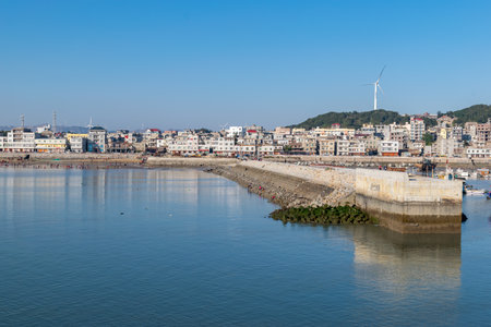 The wharf of the fishing village and the dam made of stonesの写真素材