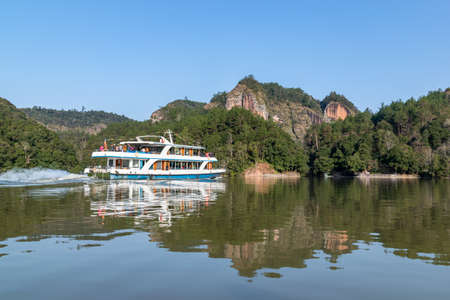 Yachts on the lake carry passengers to visit mountains and lakesの写真素材