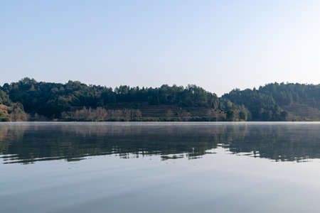 The lake reflects the mountains of Danxia landformの写真素材