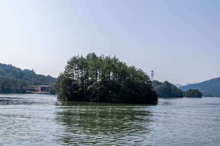 Danxia landform mountains surrounded by lake waterの写真素材
