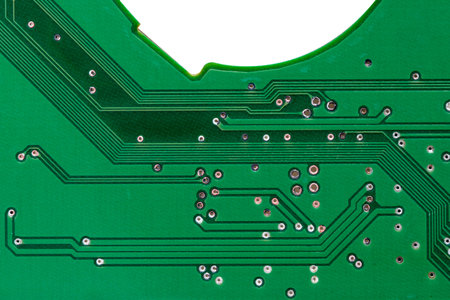 Green mechanical hard disk circuit board, local close-up on white background