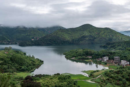 In the town after the rain, there are clouds in the mountains in the distanceの写真素材