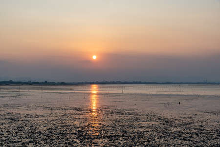 The sunset and the afterglow shone golden on the shoalの写真素材