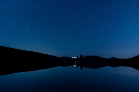 The starry sky at night on the grasslandの写真素材