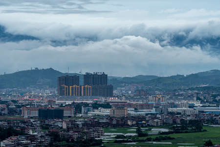 In the town after the rain, there are clouds in the mountains in the distanceのeditorial素材