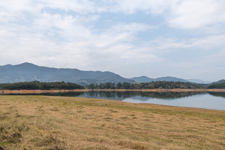 The view of the lake on a cloudy day in autumnの写真素材