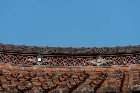 Eaves and corners made of red tiles in traditional Chinese ancient housesの写真素材