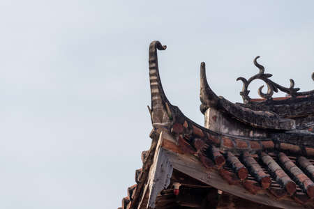 Eaves and corners made of red tiles in traditional Chinese ancient housesの写真素材