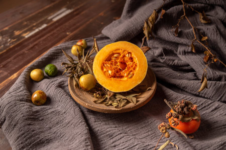 Pumpkins and many other colors and varieties of fruits and vegetables are on the wood grain table