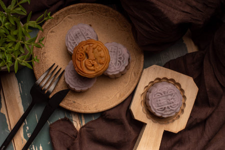 Chinese mooncakes are on the gray cloth of the wooden tableの写真素材