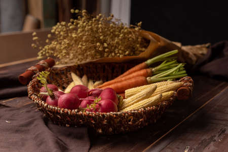 The red and orange radishes in the basketの写真素材