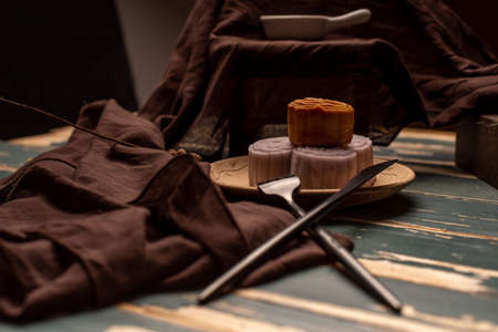 Chinese mooncakes are on the gray cloth of the wooden tableの写真素材