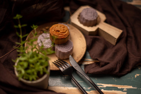 Chinese mooncakes are on the gray cloth of the wooden tableの写真素材
