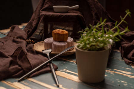Chinese mooncakes are on the gray cloth of the wooden tableの写真素材