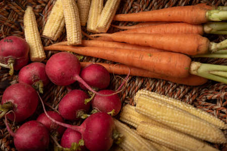 the red and orange radishes in the basketの写真素材