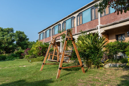 The chair or swing for people to rest on  grassland of a park