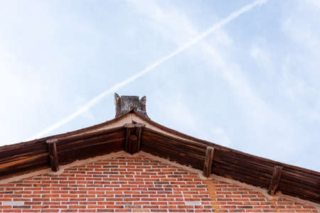 The eaves and corners of traditional Chinese residential buildings are made of red brick and limeの写真素材