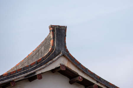The eaves and corners of traditional Chinese residential buildings are made of red brick and limeの写真素材