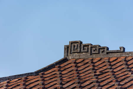 The eaves and corners of traditional Chinese residential buildings are made of red brick and limeの写真素材