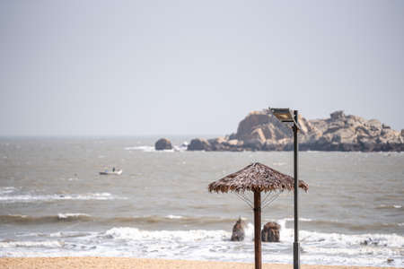grass umbrellas on the beach in summerの写真素材