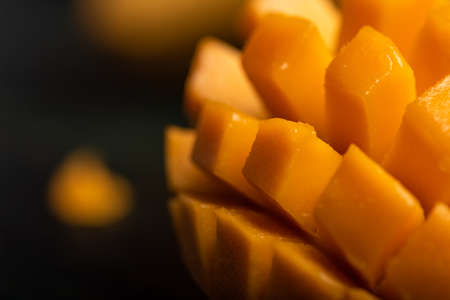 Close up of cut mango pieces against a dark backgroundの写真素材