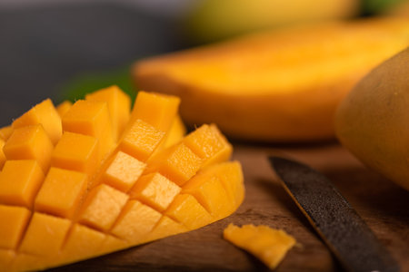 Close up of cut mango pieces against a dark backgroundの写真素材