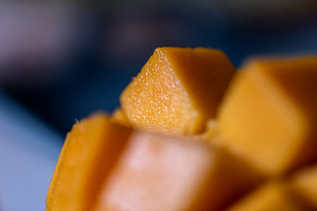 Close up of cut mango pieces against a dark backgroundの写真素材