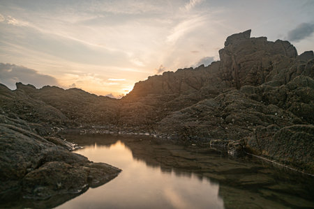 Sea water and reefs by the sea under the blue skyの写真素材